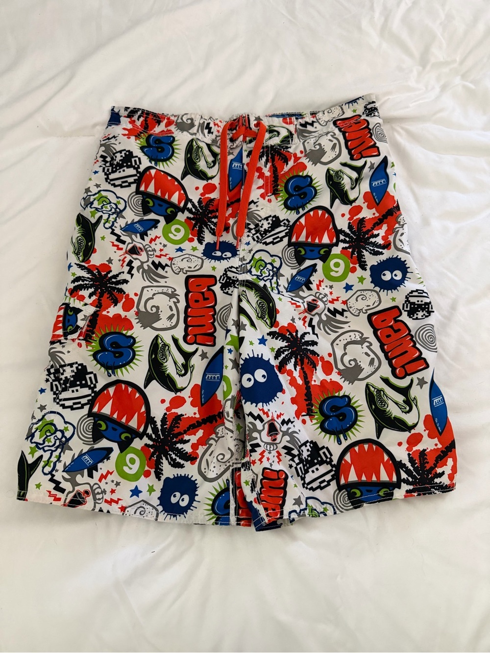 Joe Boxer Boys White Swim Trunks with Red, Blue, Green and Black Graphic Print